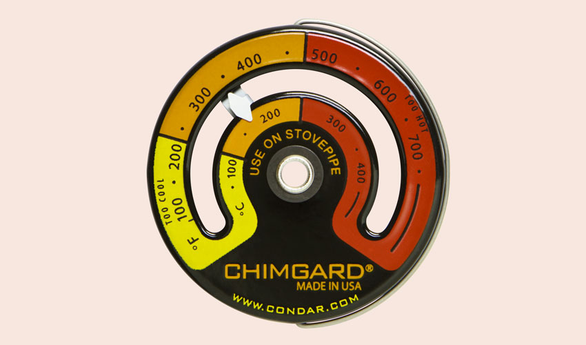 Close-up view of Condar Chimgard stovepipe thermometer and it's three zones for too cool, optimal, and too hot.