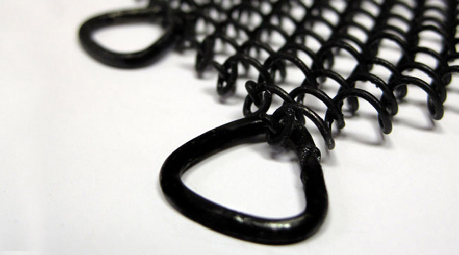 Condar mesh screens are painted with rust-inhibiting black enamel. Close-up of ring and black hanging mesh of Condar fireplace screen.