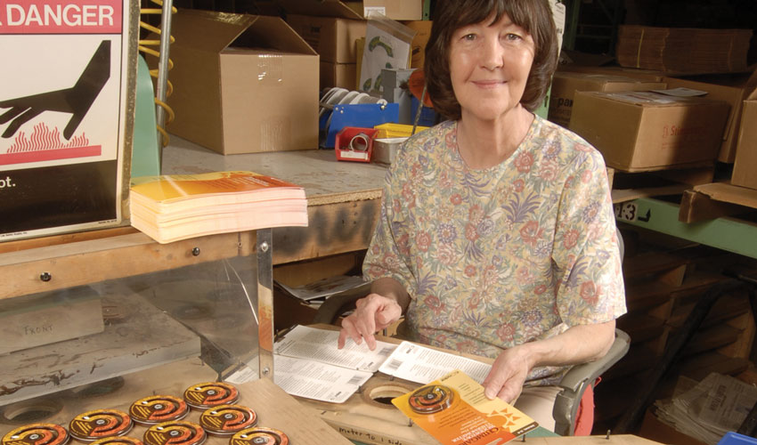 Condar workspace where thermometers are packaged onto hang card